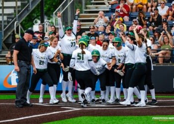 team meets at home plate after a home run.