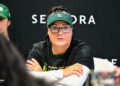 Talons Lisa Fernandez in black shirt and green visor.
