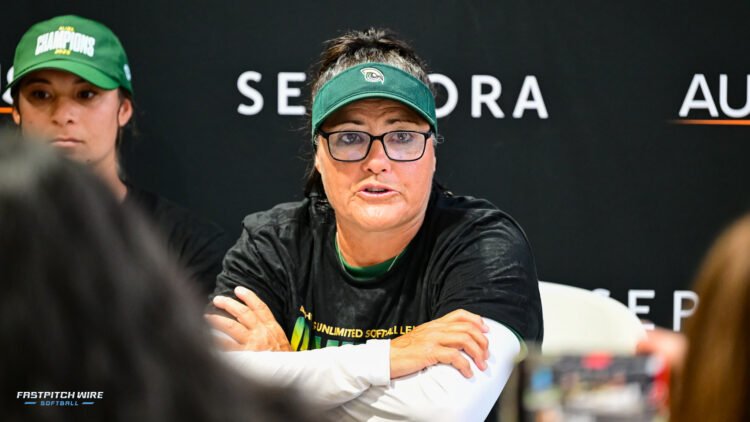 Talons Lisa Fernandez in black shirt and green visor.